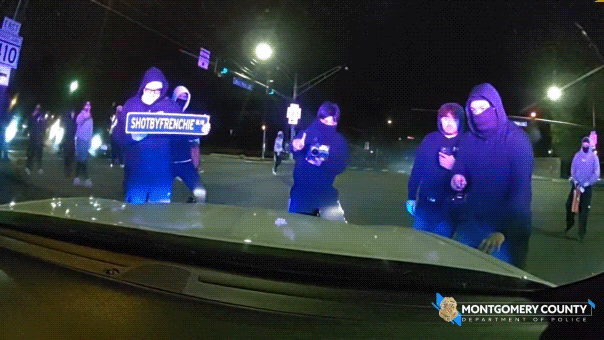 Video shows officer trapped inside cruiser as vandals smash windshield